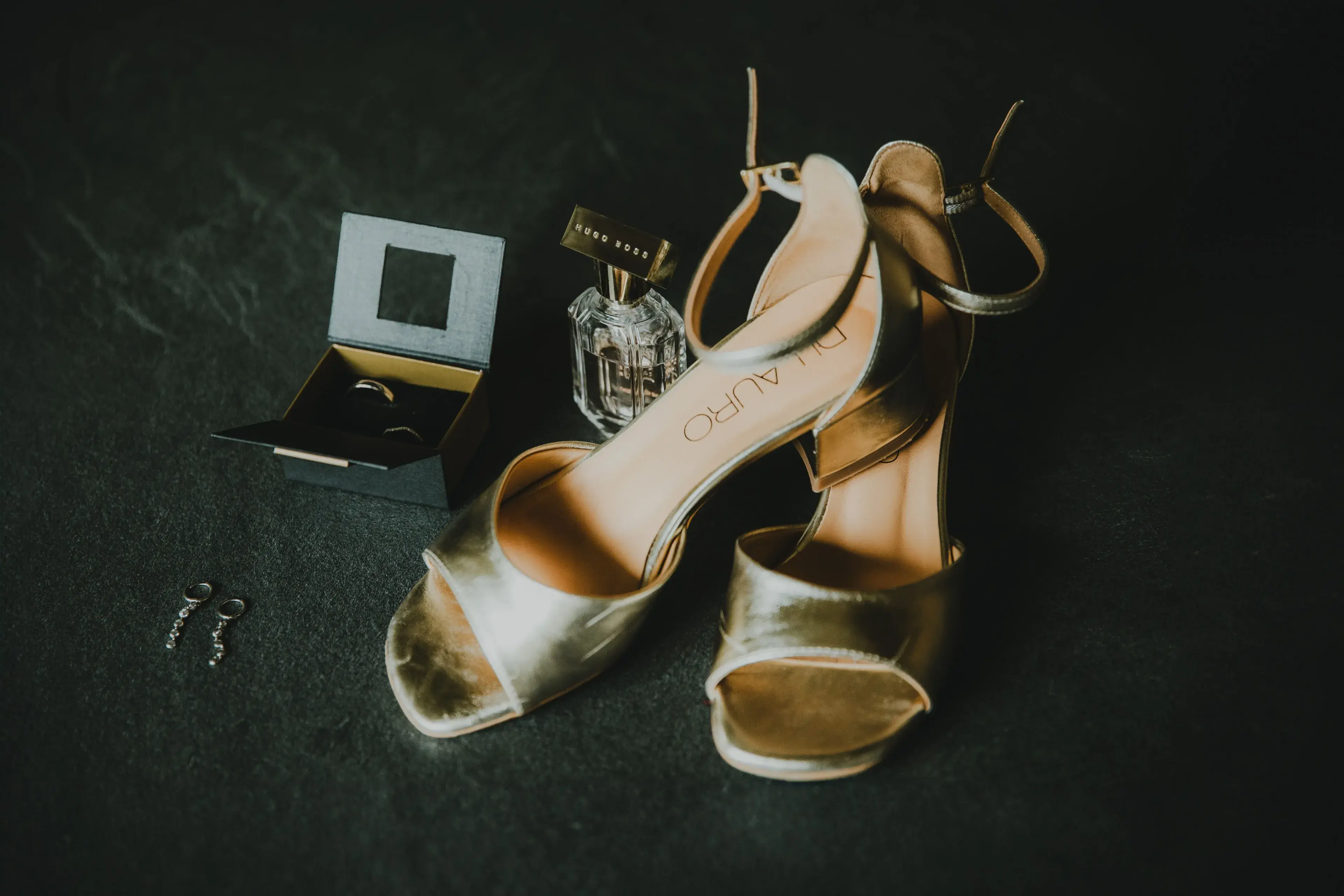 Wedding photography by Bert Van Den Eeckhaut — shoes and perfume bottle