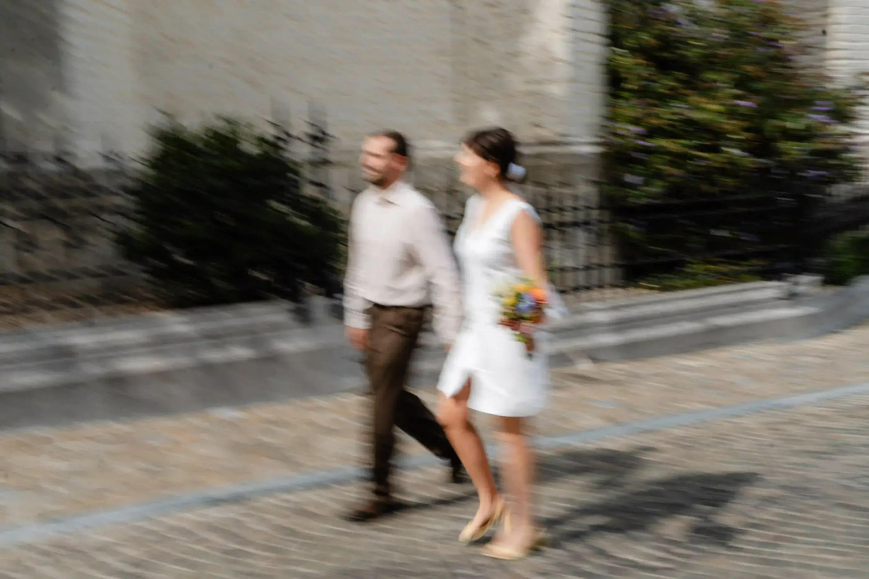 Wedding photography by Bert Van Den Eeckhaut — couple walking down cobblestone street