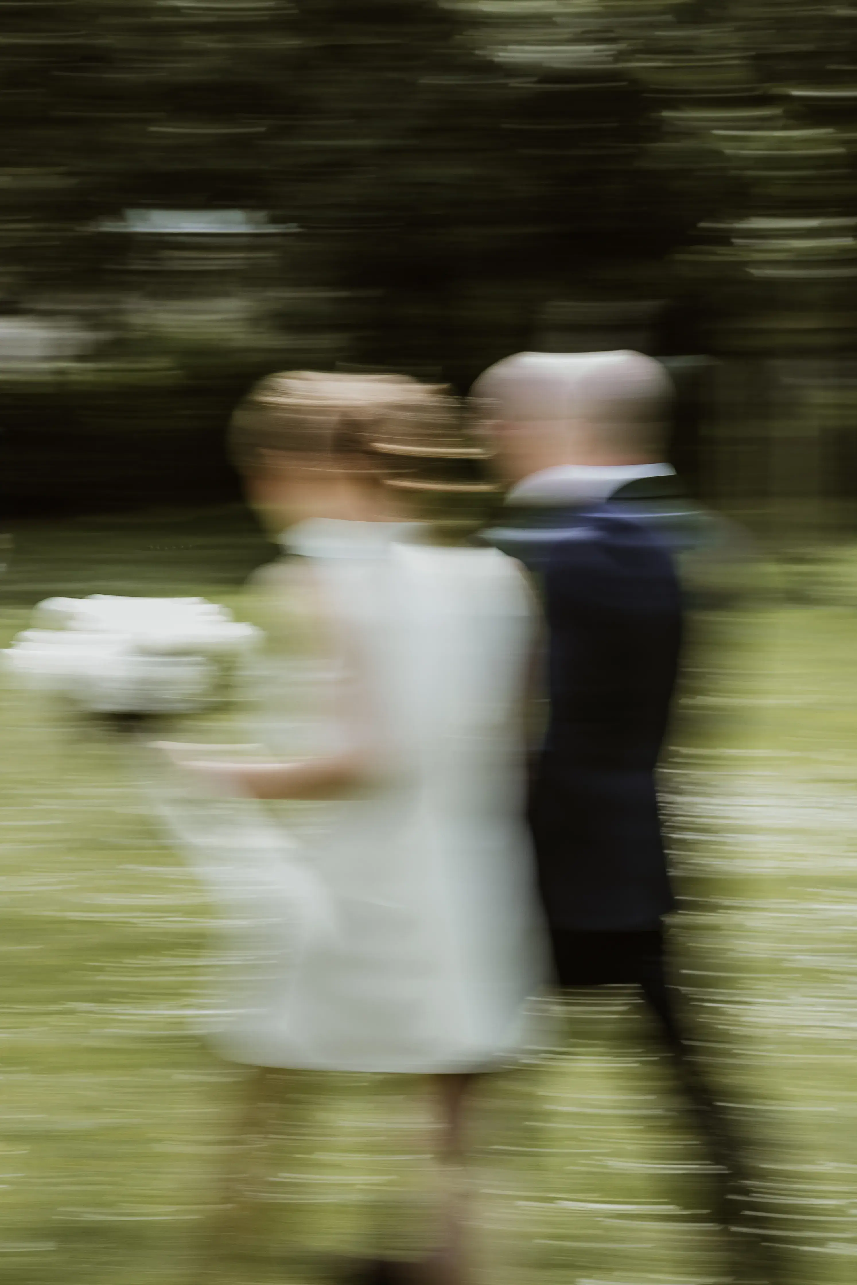 Wedding photography by Bert Van Den Eeckhaut — moving through field
