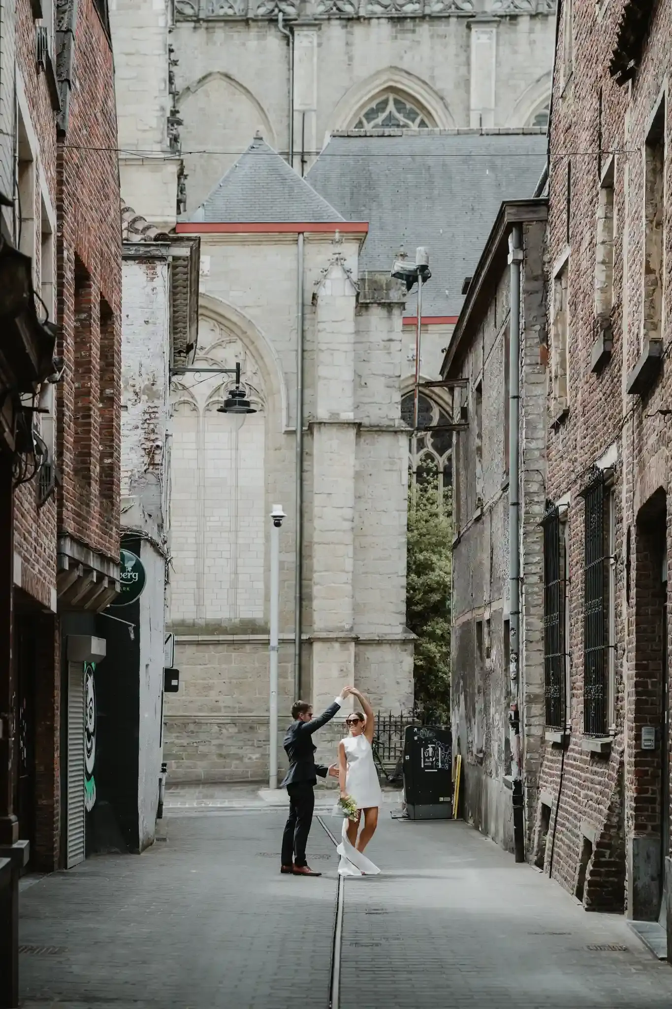 Wedding photography by Bert Van Den Eeckhaut — bride and groom at church front steps