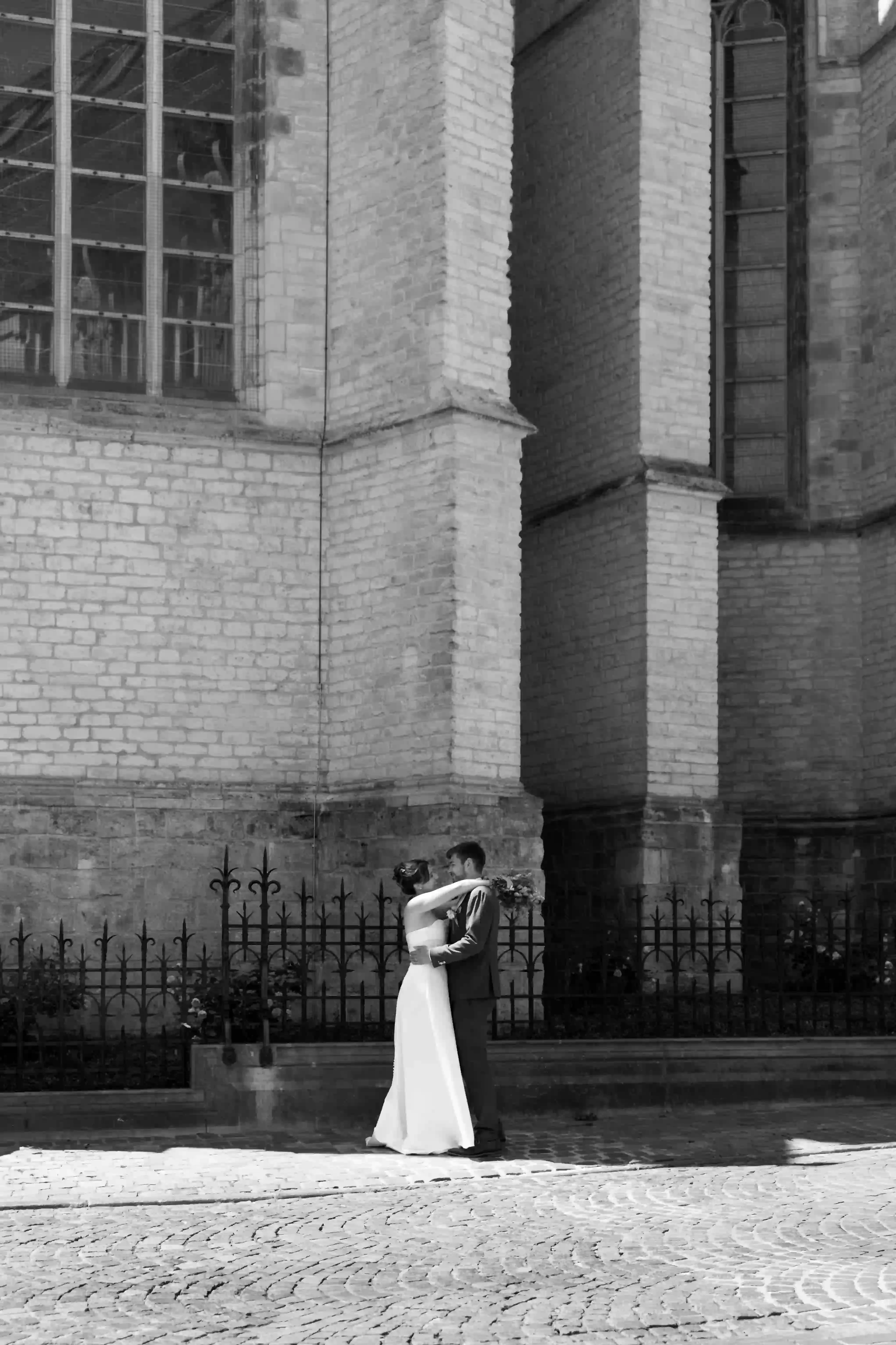 Wedding photography by Bert Van Den Eeckhaut — couple kissing church alleyway